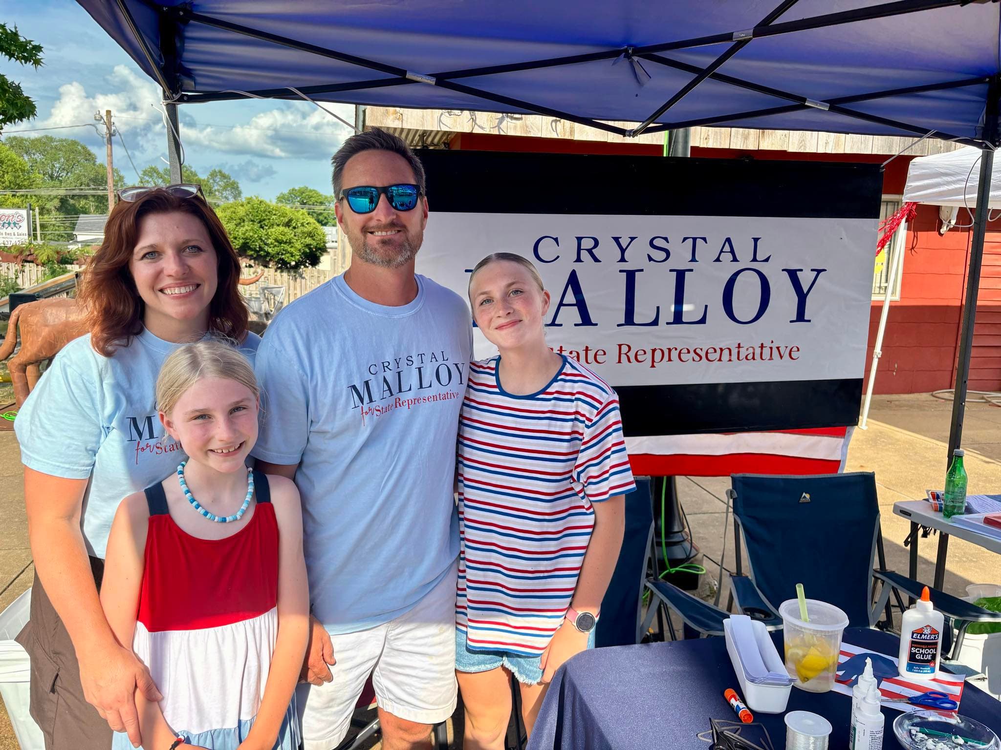 Crystal at campaign booth with family